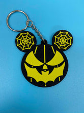 Load image into Gallery viewer, Black and yellow bat mouth jack-o-lantern with spiderweb mouse ears keychain.