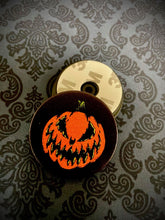Load image into Gallery viewer, Front and back view of phone grip displaying the Bad Company jack-o-lantern.