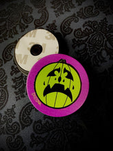 Load image into Gallery viewer, Front and back view of purple phone grip with green Chillona jack-o-lantern.