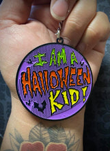 Load image into Gallery viewer, Hand holding keychain that says &quot;I am a Halloween kid!&quot;