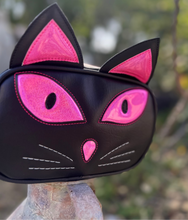 Load image into Gallery viewer, Black cat-shaped Purse with pink accents on a blurred natural background