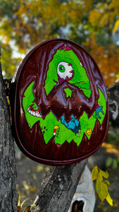 Handcrafted Rotten Egg Oval: Red Glitter and green Grave Offerings material