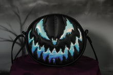 Load image into Gallery viewer, Bad Company pumpkin Black handbag with holographic textured vinyl pumpkin face with green stitching. 