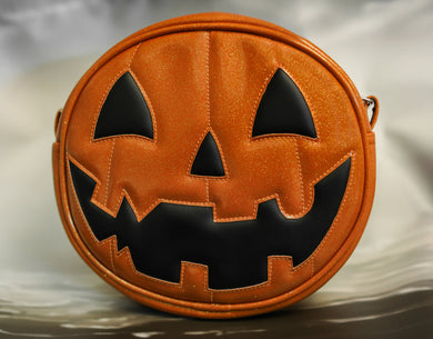 Orange Glitter vinyl and Black vinyl happy pumpkin face bag. 