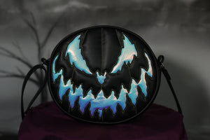 Bad Company pumpkin Black handbag with holographic textured vinyl pumpkin face with green stitching. 