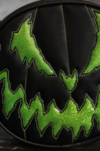 Evil faced pumpkin bag in Black vinyl and Green glitter vinyl . Close up of the face. 