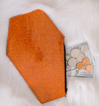 Load image into Gallery viewer, Orange glitter coffin shaped coin bag with orange stitching and a black zipper with two Hundred dollar bills, three quarters a nickel and a penny sticking out of it 