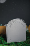 Back view of grey headstone wallet debossed with "see you soon"