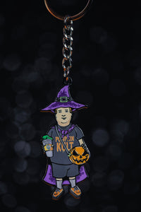 Basic Witch kid keychain with "pumpkin cult" shirt, purple witch hat, purple cape, orange shoes,  pumpkin spice drink, and our signature pumpkin bag in orange and black.  