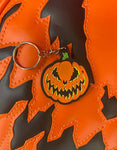 Close up of keychain of jack-o-lantern with Bad Company face.