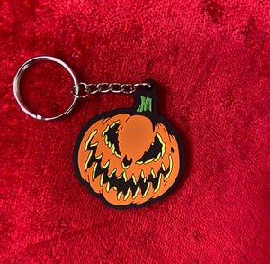 Detailed close up of keychain of jack-o-lantern with Bad Company face.