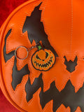 Keychain of jack-o-lantern with Bad Company face.