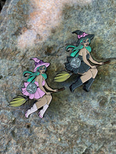 Load image into Gallery viewer, Enamel pins of two witches with mint hair riding brooms.