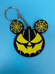 Black and yellow bat mouth jack-o-lantern with spiderweb mouse ears keychain.