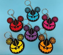 Load image into Gallery viewer, 6 rubber spiderweb ear key chains on blue background. 