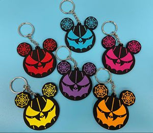6 rubber spiderweb ear key chains on blue background. 