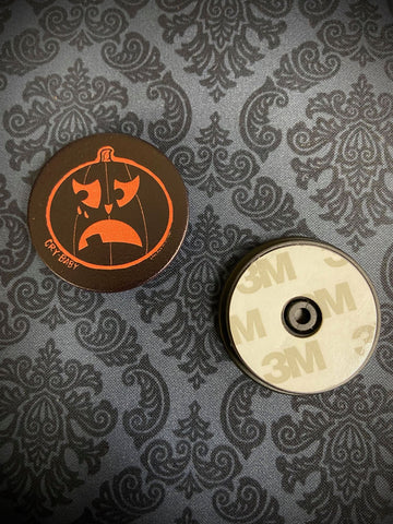 front and back view of phone grip with a Cry Baby jack-o-lantern.