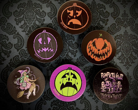 Six phone stands in various spooky designs.