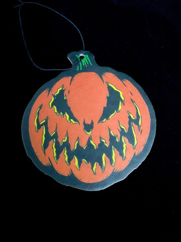 Paper air freshener of a Jack-o-lantern with the Bad Company face. 