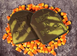 Close up view of two thermal sensitive tombstone shaped wallets that say "Rest In Peace"