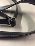 Close up of a black strap with chrome hardware