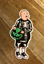 Load image into Gallery viewer, Boy with Skeleton Costume and a Pumpkin Purse sticker with a Wooden Background