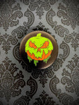 Front view of jack-o-lantern with goo dripping into skull face phone grip.