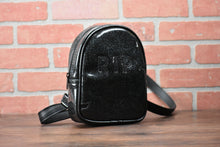 Load image into Gallery viewer, Black glitter small headstone back pack with &quot;RIP&quot; across the front.  Photographed in front of brick wall. 