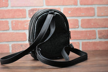 Load image into Gallery viewer, Black glitter small headstone back pack with &quot;RIP&quot; across the front.  Photographed in front of brick wall. Back of bag. 