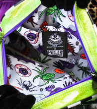 Load image into Gallery viewer, Inside of monster bag, the fabric has eyeballs, spiders, and other bugs on it. 