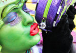 close up of the girl kissing the vampire fang zipper of the monster bag