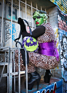 Girl dressed as monster wearing the monster bag, Glitter Purple and green glitter bag has black and white glitter pipping , green matching zipper